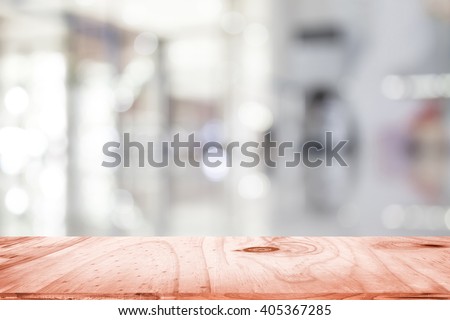 empty brown wooden table and interior blur background with bokeh image, for product display montage. Selected focus