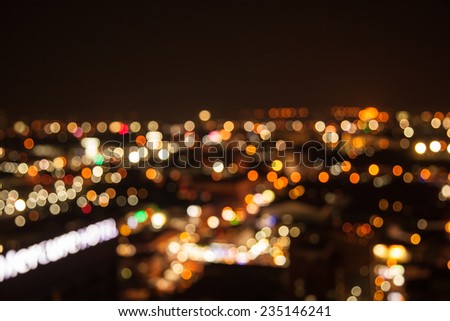 defocused bokeh of light in city on yellow background