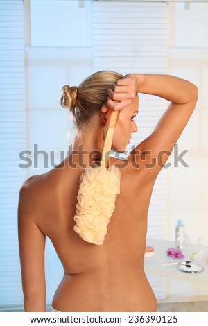woman brushing her back