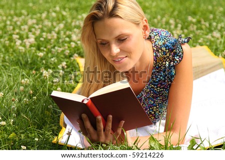 Beautiful young blond Woman reading a book at her break