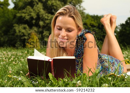 Beautiful young blond Woman reading a book at her break