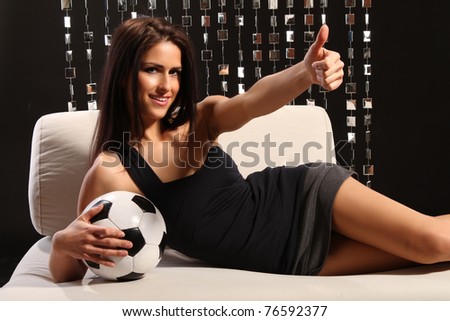 Woman on couch with football