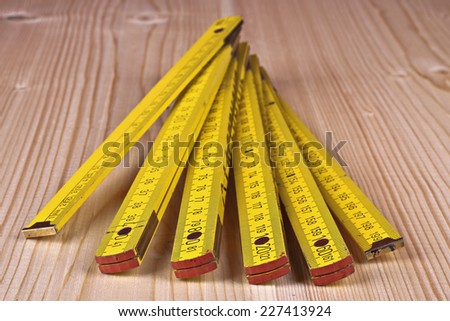 Yellow wooden meter on the the wooden background
