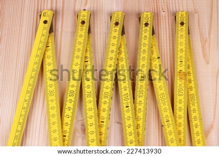 Yellow wooden meter on the the wooden background