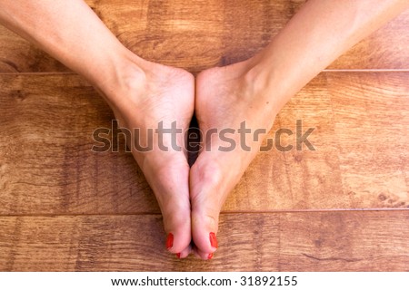 Two feet placed together on a wodden background