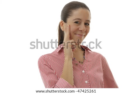 Smiling attractive business woman with a red shirt holding fingers on the side of her face on a white background