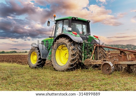 Karlovo, Bulgaria - August 22th, 2015: Ploughing a field with John Deere 6930 tractor. John Deere 8100 was manufactured in 1995-1999 and it has JD 7.6L or 8.1L 6-cyl diesel engine.