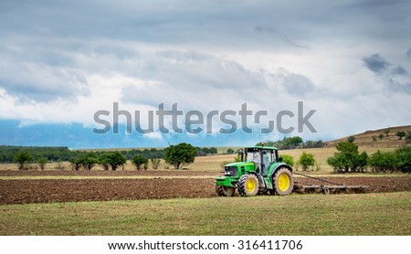 Karlovo, Bulgaria - August 22th, 2015: Ploughing a field with John Deere 6930 tractor. John Deere 8100 was manufactured in 1995-1999 and it has JD 7.6L or 8.1L 6-cyl diesel engine.