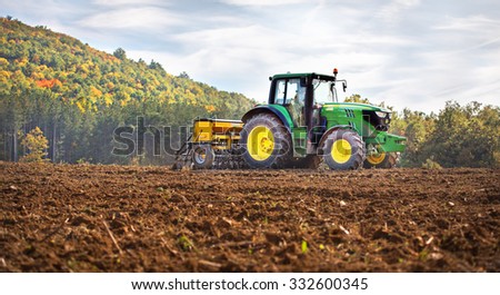 Rish, Bulgaria - Octomber 26th, 2015 Ploughing a field with John Deere 6930 tractor. John Deere 8100 was manufactured in 1995-1999 and it has JD 7.6L or 8.1L 6-cyl diesel engine.