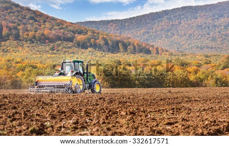 Rish, Bulgaria - Octomber 26th, 2015 Ploughing a field with John Deere 6930 tractor. John Deere 8100 was manufactured in 1995-1999 and it has JD 7.6L or 8.1L 6-cyl diesel engine.