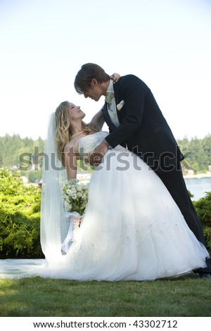 The bride and groom pose after