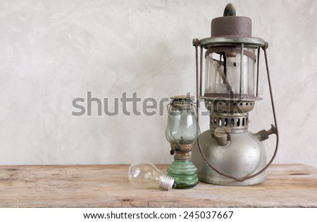 Vintage kerosene lamp and Tungsten lamp on wooden table
