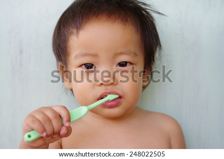 little Baby boy  brushing his teeth ,child learning to brush teeth and toothpaste