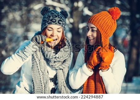 Young beautiful girls friends are in the winter forest. winter theme