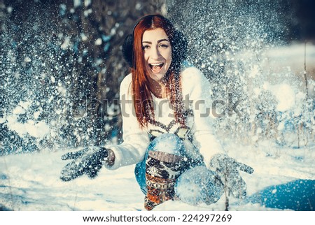 Young beautiful girl are in the winter forest. winter theme