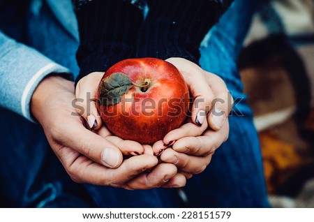 Beautiful young couple holding red apple autumn theme