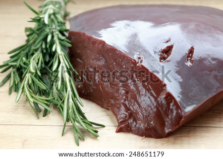 Beef liver with branch of rosemary
