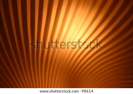 orange colored curved lines make an abstract close up of light cover, background art.