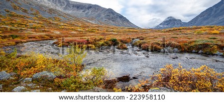 Colorful autumn tundra behind the Malaya Belaya river bend in Hibiny mountains above the Arctic Circle, Russia