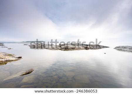 Minimalist landscape with small rocky island in Ladoga lake, Karelia, Russia