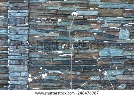 Frost texture of brick wall fence built from irregular blocks