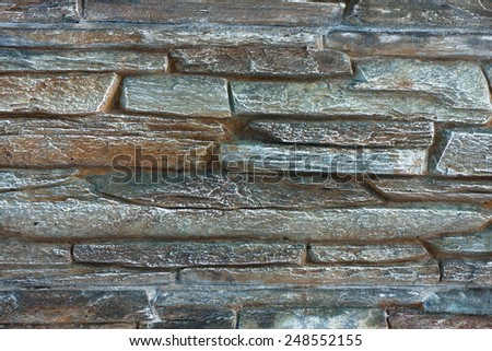 Frost texture of brick wall fence built from irregular blocks