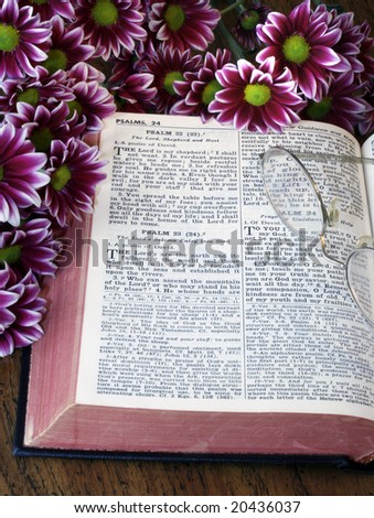 open bible, flowers and glasses