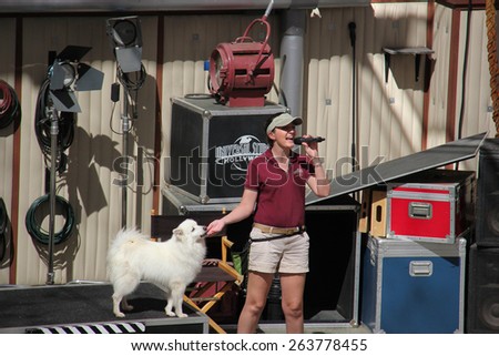 Los Angeles, California, USA - March 12, 2015: The trainer and trained dog are performing in Animal Show at Universal Studios Hollywood.
