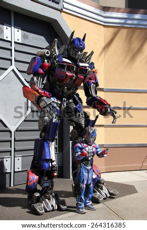 Los Angeles, California, USA - March 12, 2015: The Impersonator of Transformers movie is welcoming tourists in front of the Transformers Ride at Universal Studios Hollywood.