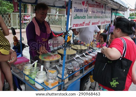 Bangkok, Thailand - May 2, 2015: People are buying food from street food vendor. Thai street food is easy to be found, authentic, cheap and delicious.