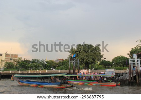 Bangkok, Thailand - May 8, 2015: Passengers are waiting for a river ferry to cross Chao Phraya River at a pontoon in Bangkok, Thailand.