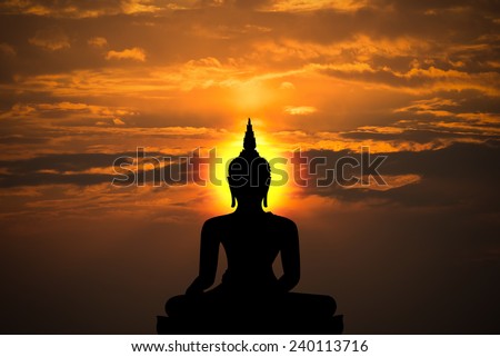 buddha statue,silhouette of buddha and sunset background with blur motion