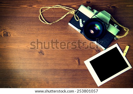 Vintage camera on wooden background.Vintage tone.