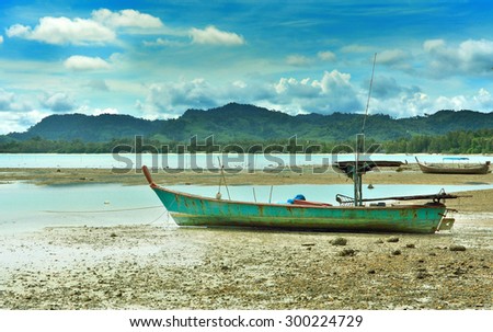 Old fishing boats a  beach parking lot in the hurricane season,Phanga Thailand .