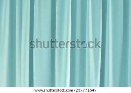 Light blue closed curtain background.