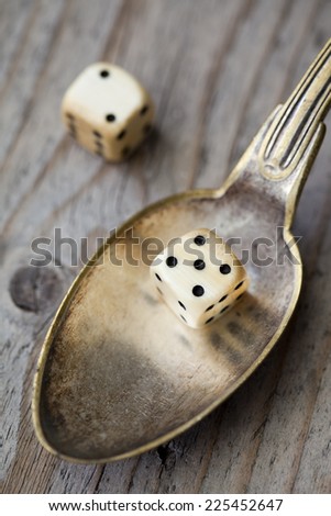 A spoon with two dices illustration the popular 5:2 diet
