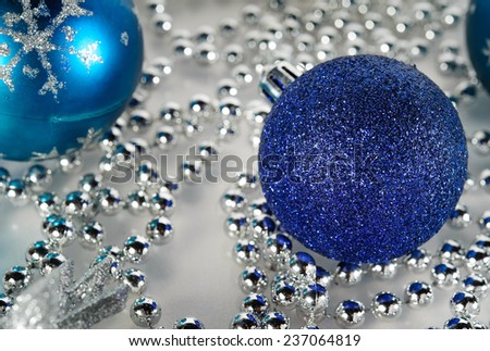 Christmas decorations, blue ball, silver beads on white background