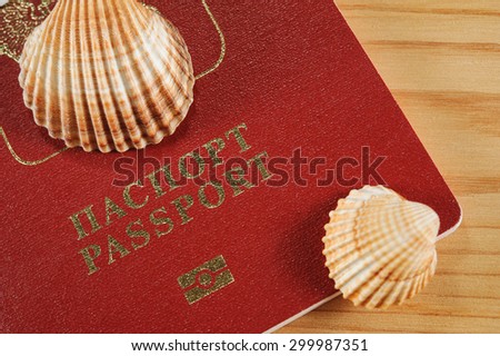 passport closeup and shells, time to go on vacation