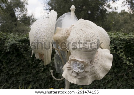 straw hat on a coat rack in a garden. vintage image