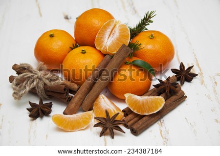 Christmas composition with fresh mandarin oranges, cinnamon, anise on old wooden background