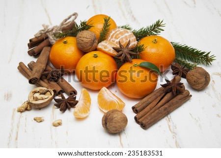 Christmas composition with fresh mandarin oranges, cinnamon, anise, walnuts on old wooden background