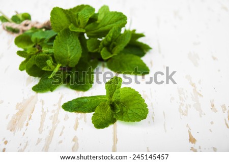 Bunch of mint on a wooden background. Peppermint