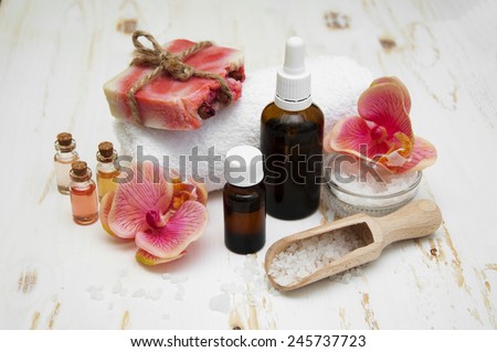 Spa composition. Sea salt, essential aroma oil on wooden background