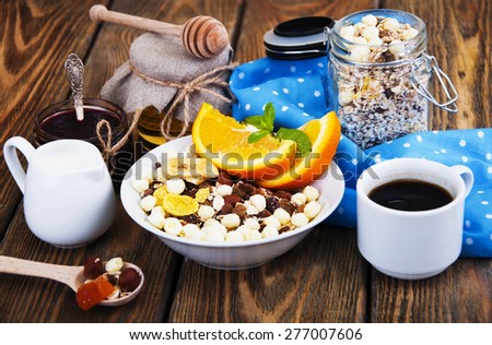 Healthy breakfast of oatmeal,coffee,fresh juice,honey, jam and oranges on a wooden background