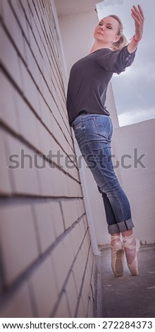 ballerina standing with her  ballet pointe shoes outdoor