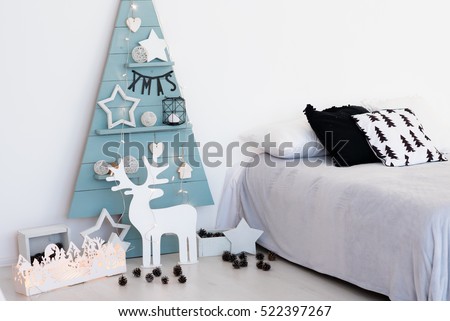 Christmas decorations christmas stylish. Blue wood tree with lights and other decoration, deer, stars and cones.