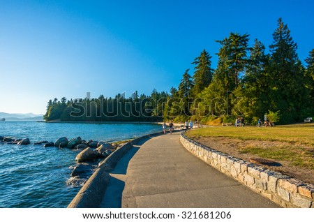 VANCOUVER, BC/CANADA - JULY 30: People at Stanley Park Seawall in Vancouver, Canada on July 30, 2015. Park visitors walk, bike, roll, and fish on the 22 kilometers seawall route.