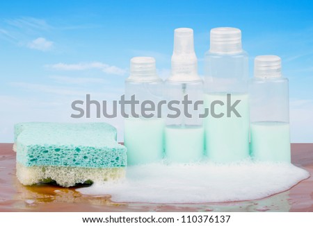 Four bottles of soap with bubbles and sponge
