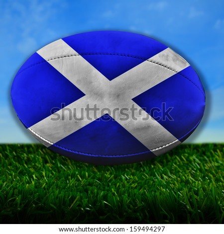 Rugby ball with Scotland flag over grass