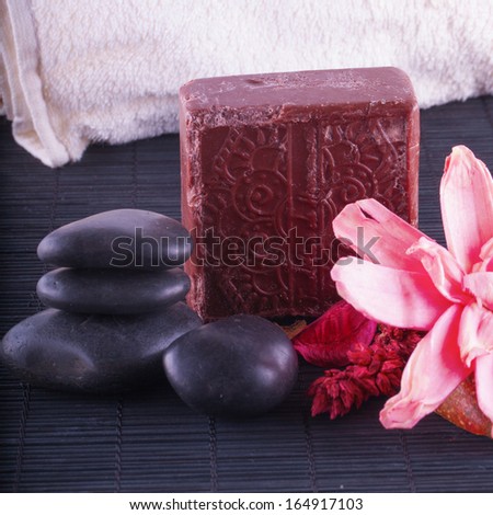 Hammam (Turkish Bath) interior, with brown soap, stones, towel and flowers